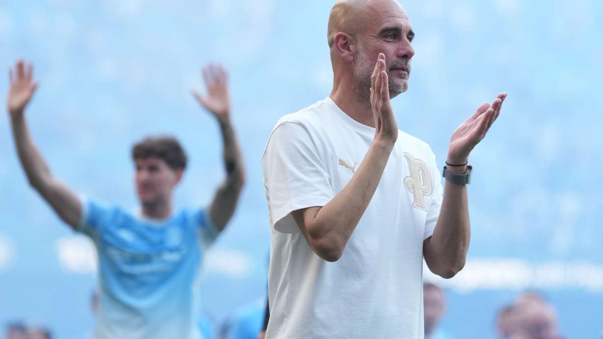 FILE - Manchester City's head coach Pep Guardiola applauds the fans after his last game with the club after a Premier League soccer match between Manchester City and Aston Villa in Manchester, England, May 24, 2026.