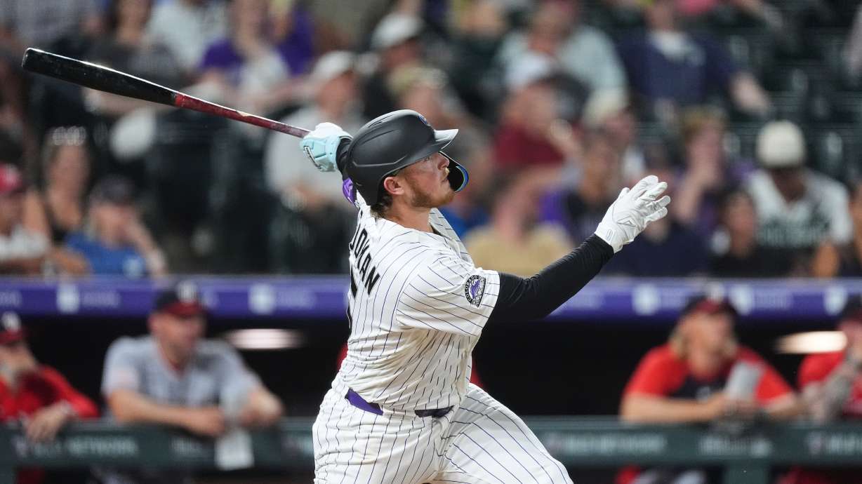 Colorado Rockies' Hunter Goodman follows the flight of his solo home run off Washington Nationals relief pitcher Clayton Beeter in the eighth inning of a baseball game Tuesday, July 21, 2026, in Denver.