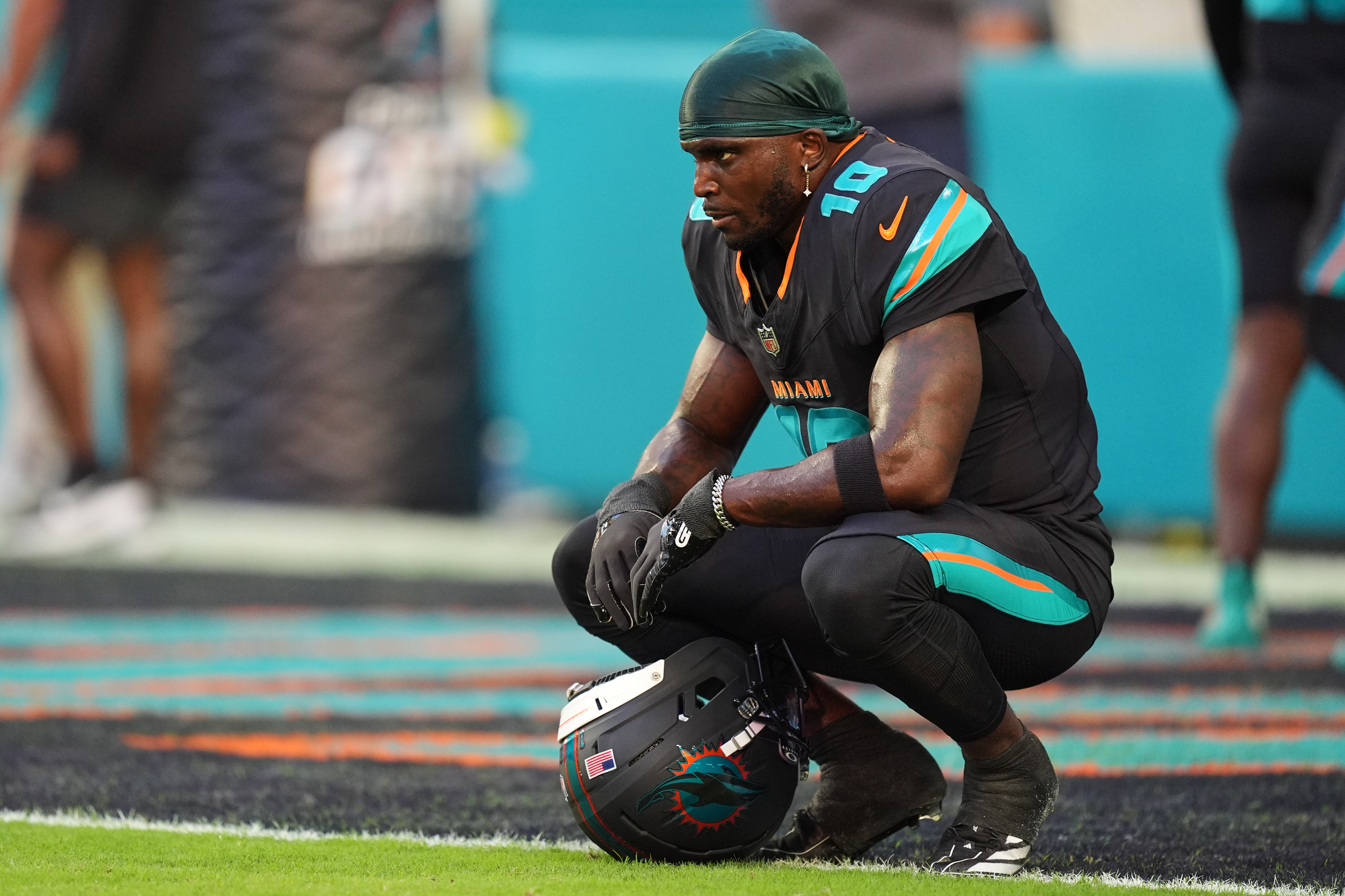 FILE - Miami Dolphins wide receiver Tyreek Hill sits in the end zone before an NFL football game against the New York Jets, Sept. 29, 2025, in Miami Gardens, Fla. 