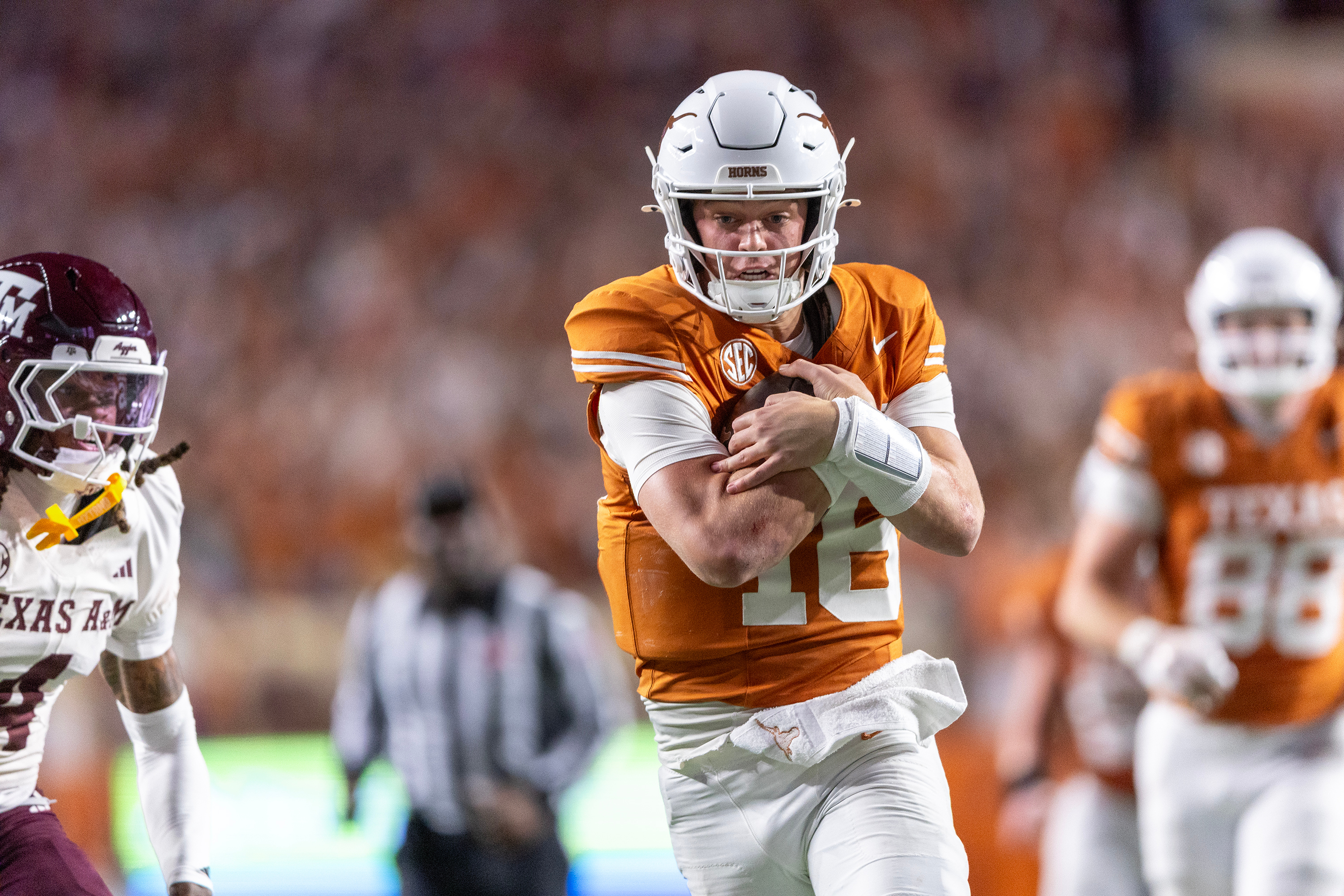 FILE - Texas quarterback Arch Manning (16) scores a touchdown past Texas A&M cornerback Will Lee III (4) during the second half of an NCAA college football game Friday, Nov. 28, 2025, in Austin, Texas. 