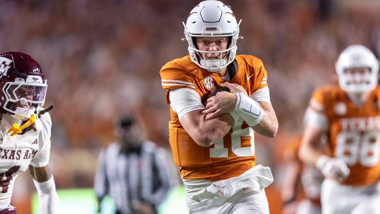 FILE - Texas quarterback Arch Manning (16) scores a touchdown past Texas A&M cornerback Will Lee III (4) during the second half of an NCAA college football game Friday, Nov. 28, 2025, in Austin, Texas.