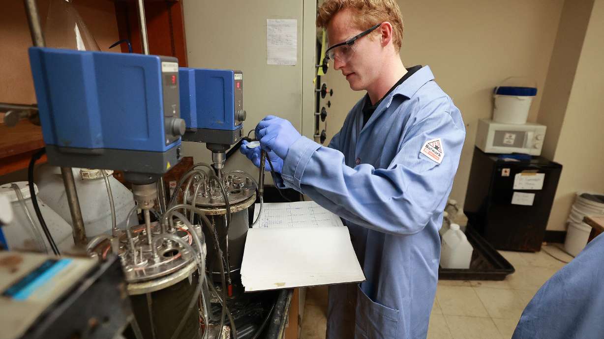 Hyrum Johnson, University of Utah graduate researcher, checks the health and performance of bacteria that consume pyrite minerals in the Bioreactor Lab at the University of Utah in Salt Lake City on Thursday. The bacteria can be used to leach metals out of minerals.
