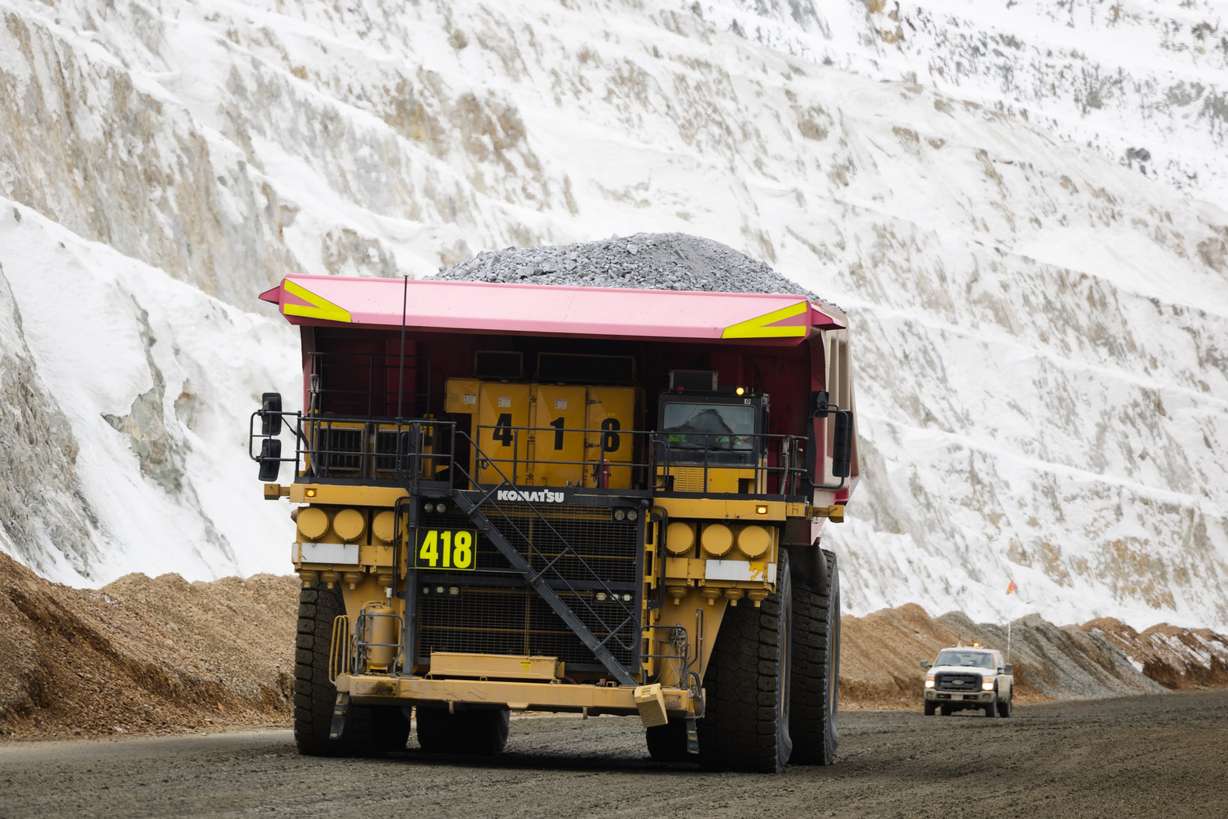 A haul truck looms over a crew truck with a full load of copper ore waste at the Rio Tinto Kennecott Copper Mine in Herriman on Feb. 20, 2023.