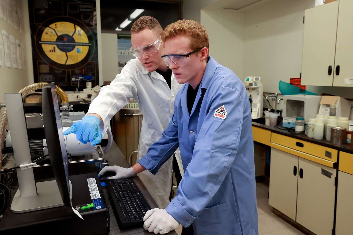 Easton Sadler, University of Utah graduate researcher, and Hyrum Johnson, University of Utah graduate researcher, work in the ICP Lab at the University of Utah in Salt Lake City on Thursday.