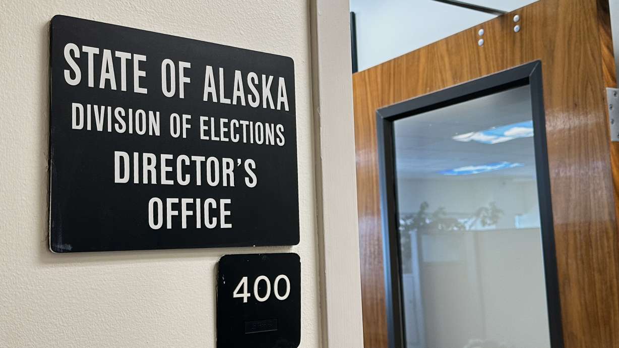 A sign hangs outside the director's office of the Alaska Division of Elections, March 19, in Juneau, Alaska.