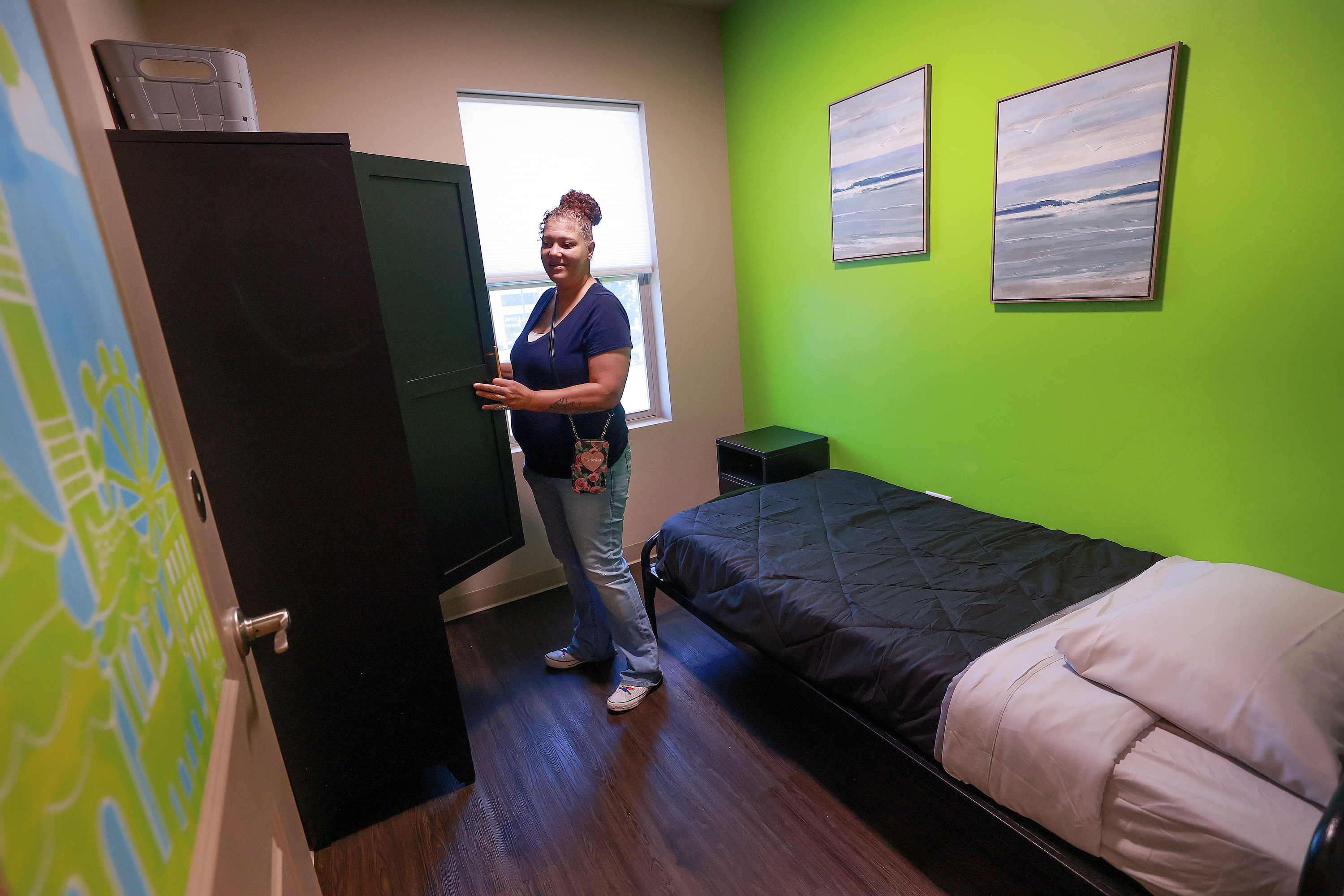 Kelly Cockrell shows what will be her room at Odyssey House Stonebridge, new housing for women with severe mental illness, in Salt Lake City on Thursday.
