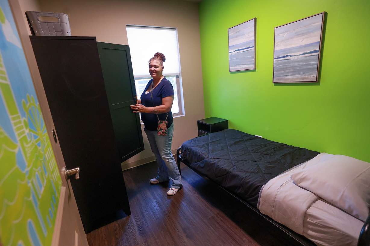 Kelly Cockrell shows what will be her room at Odyssey House Stonebridge, new housing for women with severe mental illness, in Salt Lake City on Thursday.