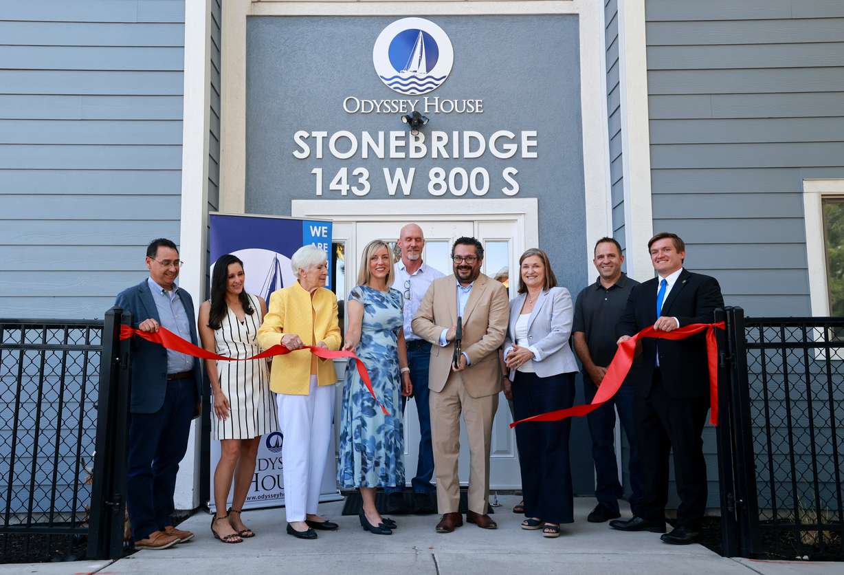 Adam Cohen, Odyssey House president and CEO, cuts the ceremonial ribbon during a ribbon cutting event for Odyssey House Stonebridge, new housing for women with severe mental illness, in Salt Lake City on Thursday.