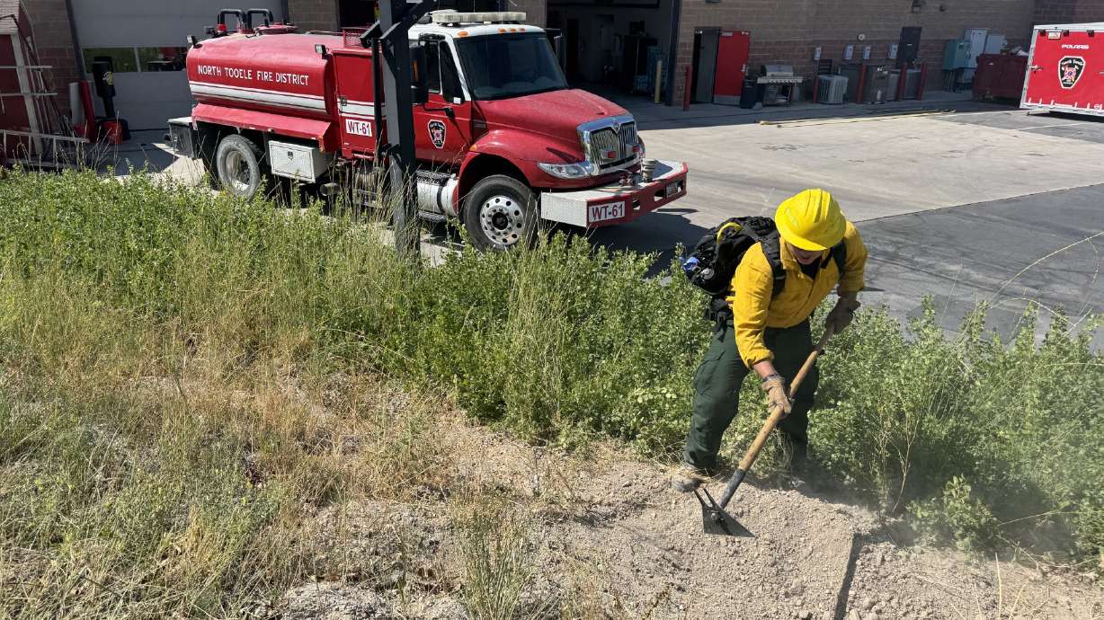 Firefighter Sean McCloy during a demonstration outside of North Tooele Fire District headquarters in Stansbury Park on Thursday.