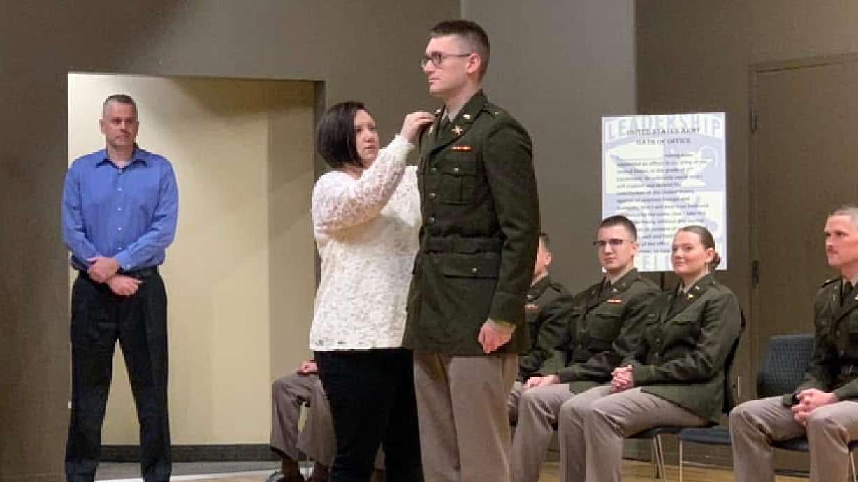 The rank of fallen U.S. Army 1st Lt. Tyler James Feehan is pinned by his mother, Shari Feehan, during the Southern Utah University ROTC commissioning ceremony. A special tribute to Feehan took center stage Thursday night