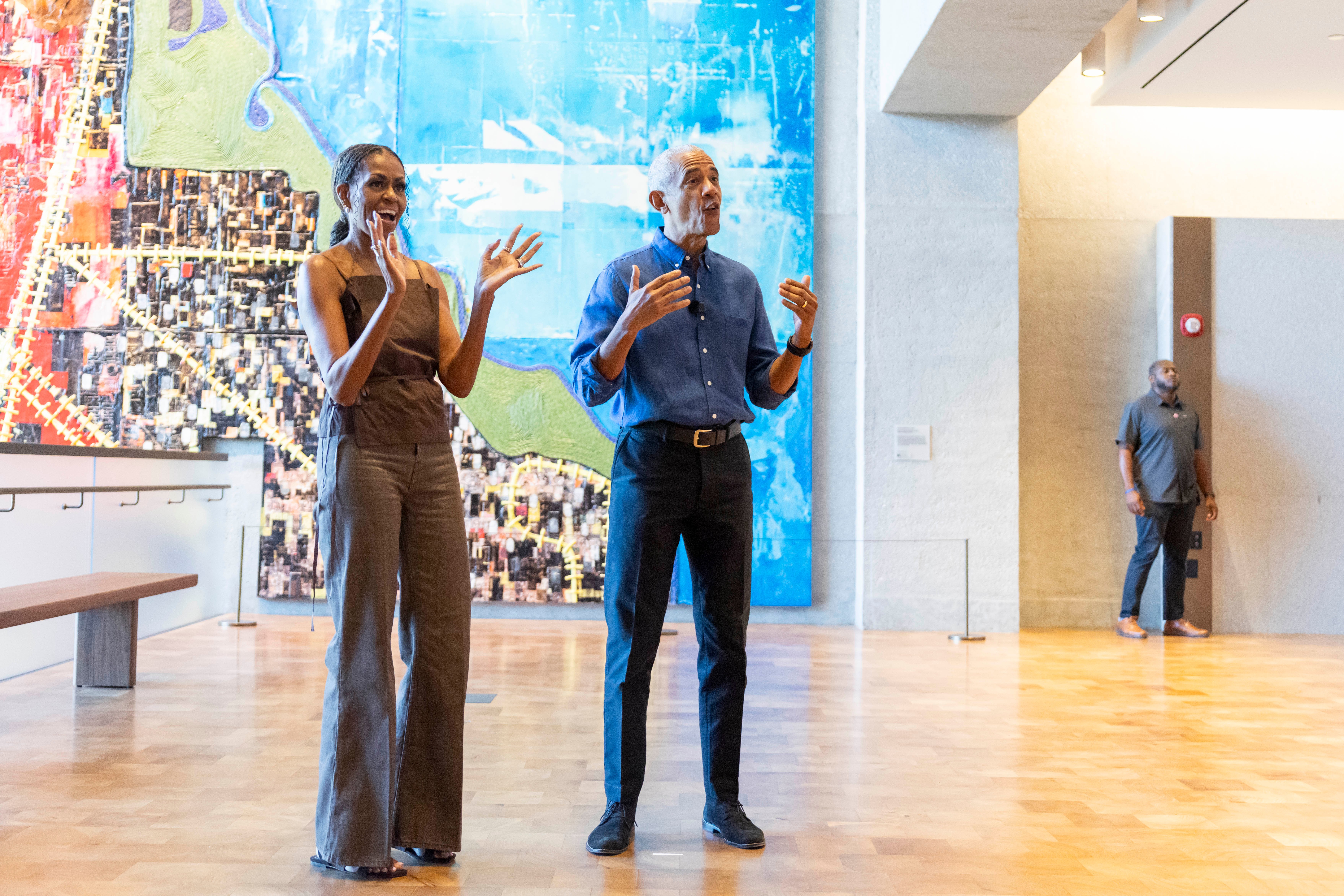 Former President Barack Obama and former first lady Michelle Obama welcome community members in the Hope and Change lobby before they walk through the museum at the Obama Presidential Center in Chicago on Friday, June 19, 2026. 