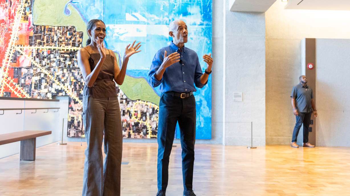 Former President Barack Obama and former first lady Michelle Obama welcome community members in the Hope and Change lobby before they walk through the museum at the Obama Presidential Center in Chicago on Friday, June 19, 2026.