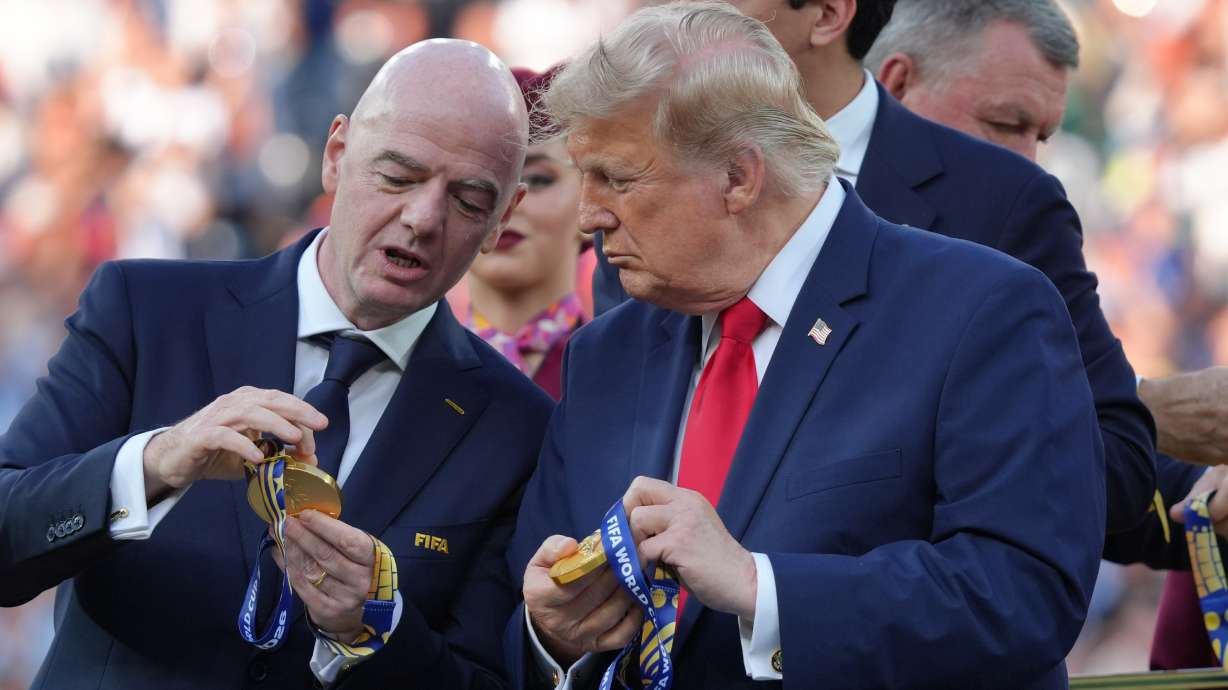 FIFA President Gianni Infantino, left, and President Donald Trump comment on the medals as they wait to congratulate the Spanish players after the World Cup final soccer match between Spain and Argentina in East Rutherford, N.J., near New York, Sunday, July 19, 2026.