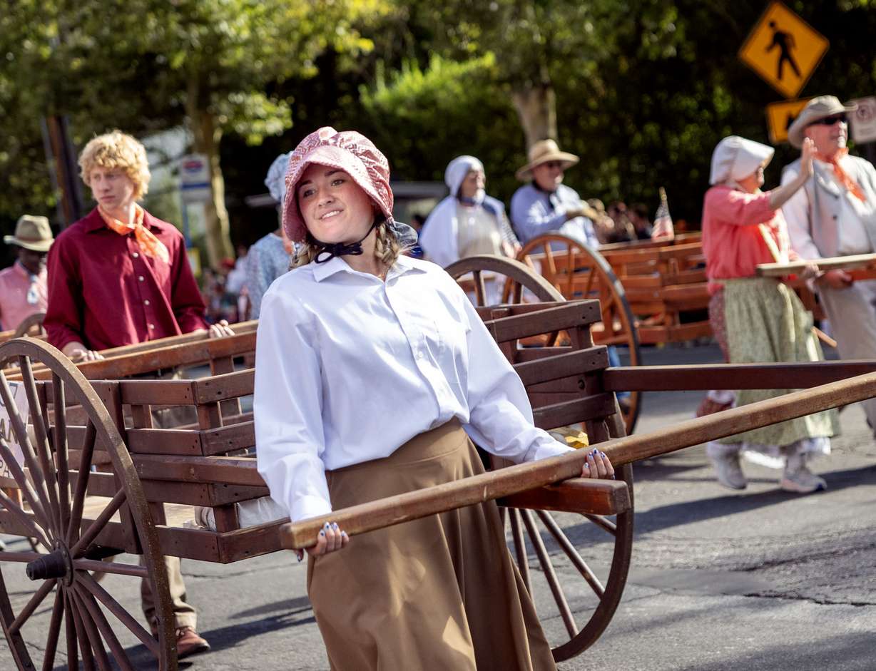 Lily Larsen of West Jordan walks with the Sons of Utah Pioneers in the Days of '47 Parade in Salt Lake City on Friday.