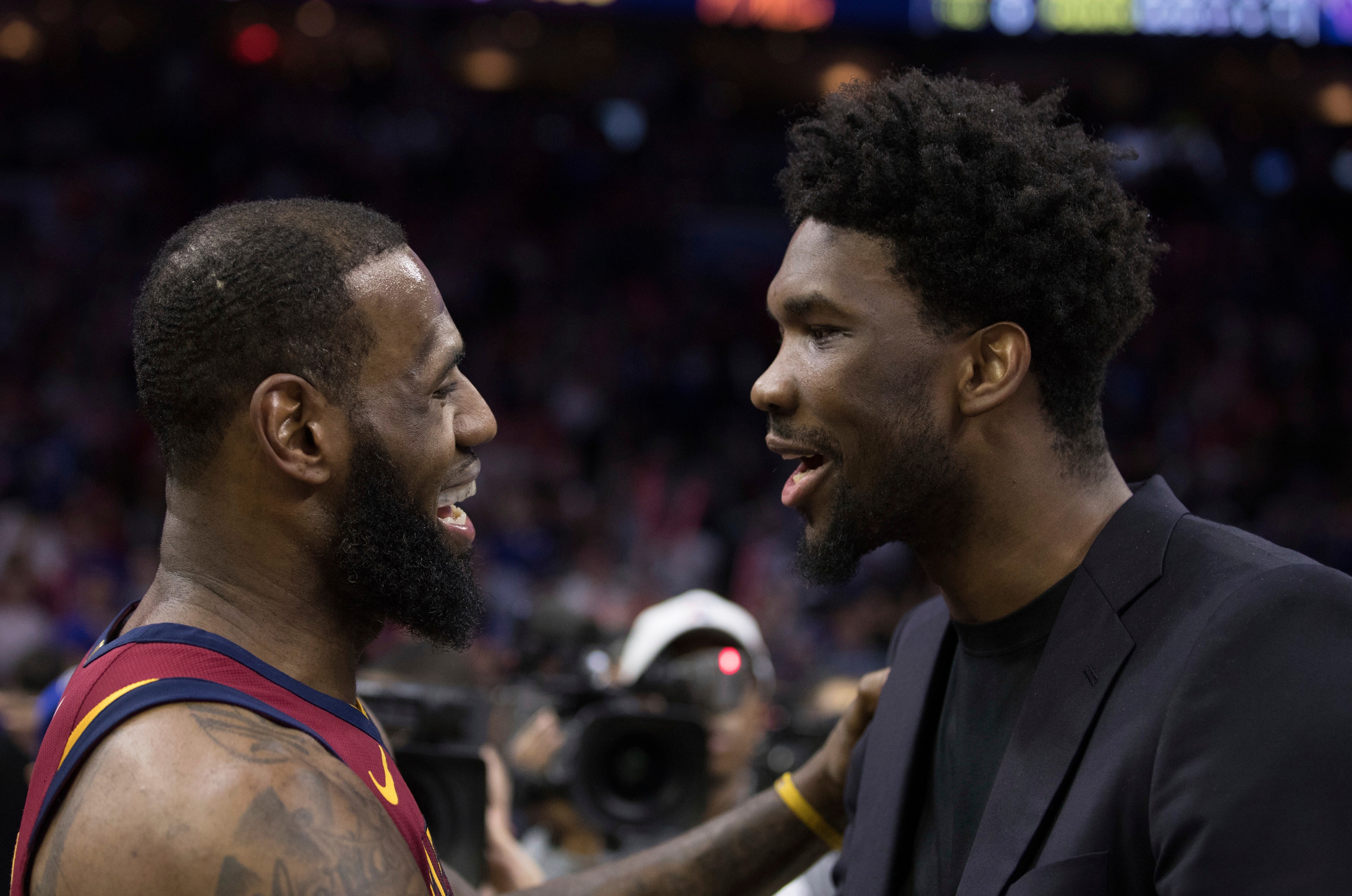 FILE - Cleveland Cavaliers' LeBron James, left, talks with Philadelphia 76ers' Joel Embiid, right, of Cameroon, after the second half of an NBA basketball game, April 6, 2018, in Philadelphia. 