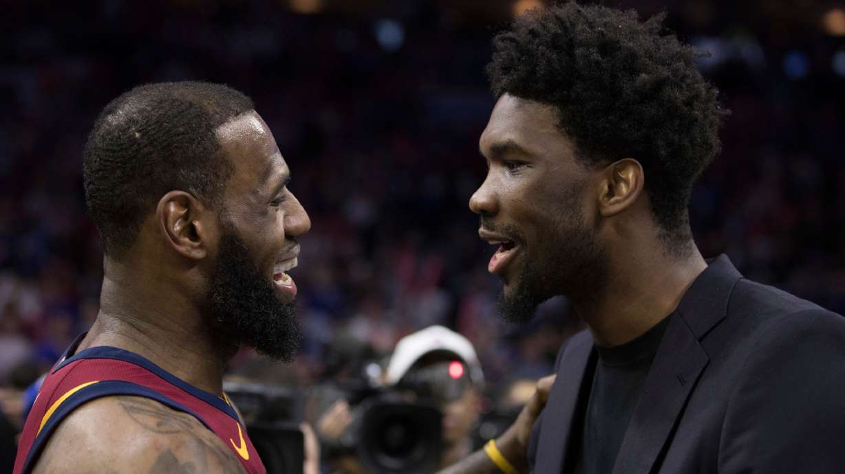 FILE - Cleveland Cavaliers' LeBron James, left, talks with Philadelphia 76ers' Joel Embiid, right, of Cameroon, after the second half of an NBA basketball game, April 6, 2018, in Philadelphia.
