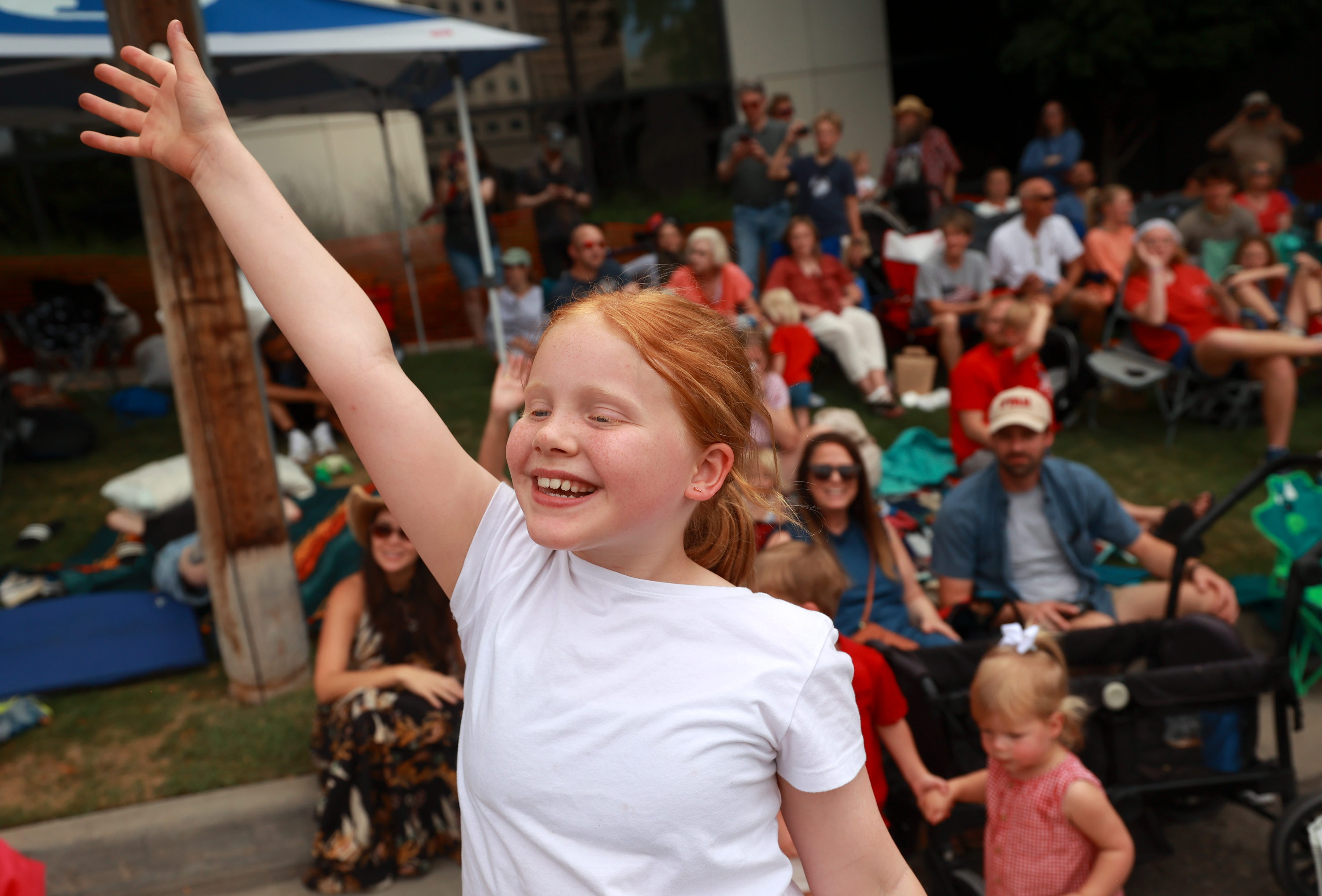 Katie Buell waves to a passing float during the Days of ’47 Parade in downtown Salt Lake City on Friday.