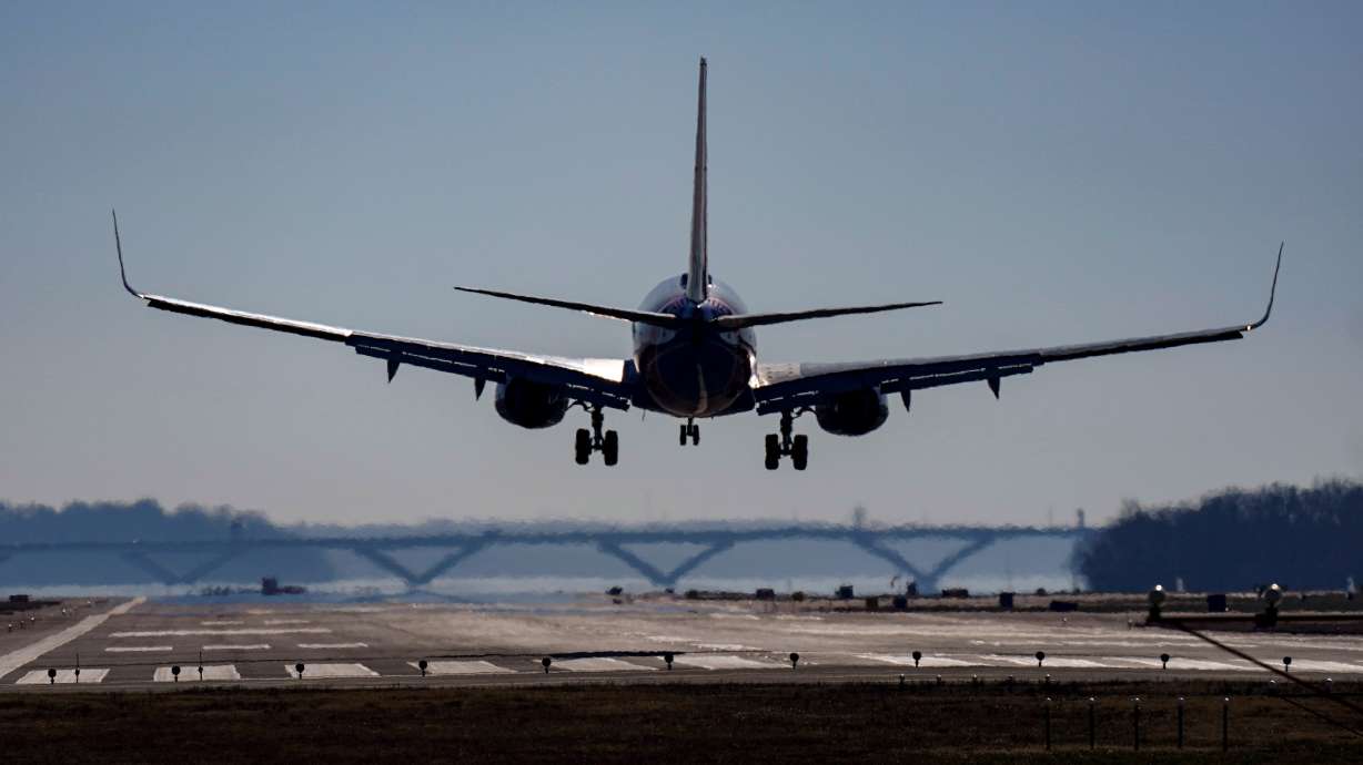 A plane lands at Ronald Reagan Washington National Airport in Arlington, Va., Dec. 30, 2022. Jet lag can turn a vacation into a slog, but you can minimize it with a few simple adjustments.