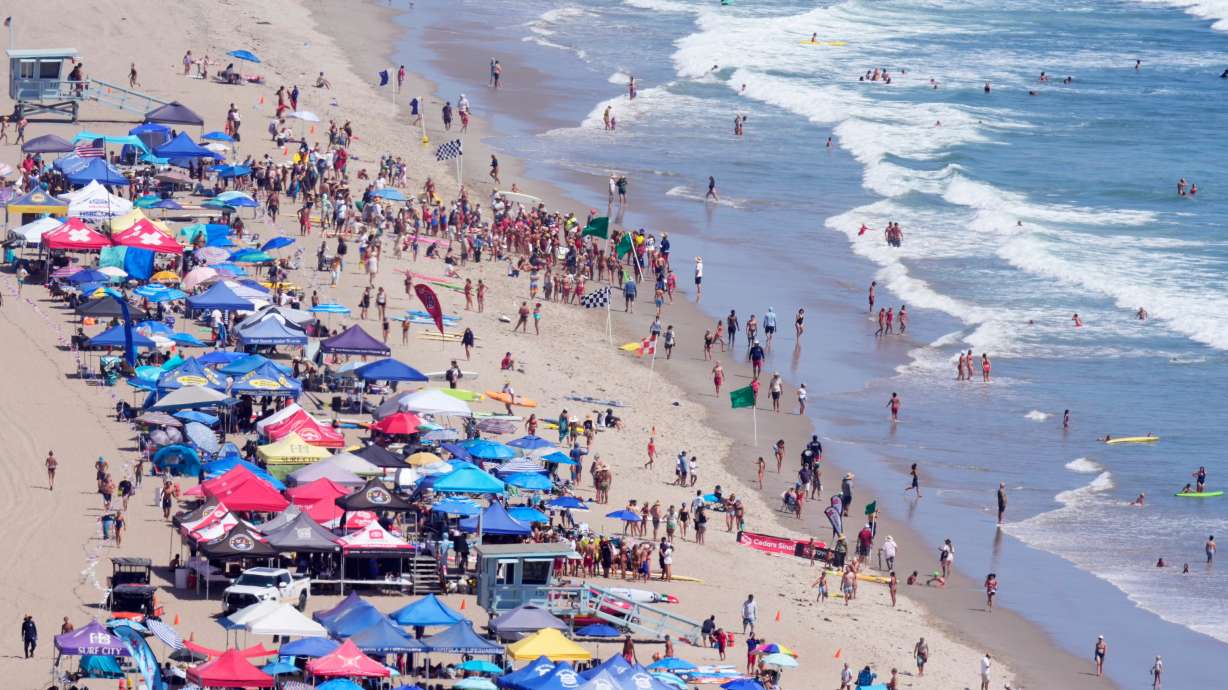 Beachgoers watch during the 46th Annual California Surf Lifesaving Championships on Will Rogers State Beach Friday in the Pacific Palisades section of Los Angeles.