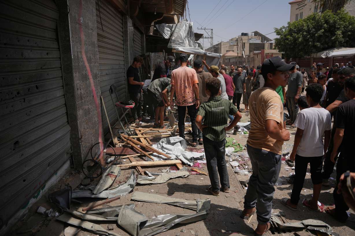 Palestinians inspect the site of an Israeli military strike, in Deir al-Balah, central Gaza Strip, Saturday. Israel's security cabinet on Sunday green-lit a proposal to allow an international stabilization force to enter the strip as part of a ceasefire deal struck in October.