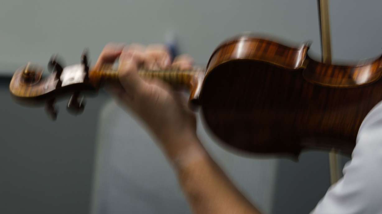 Draiblate ducks into an airport conference room with fellow violinist Paul Huang to quickly fine-tune the performance they're planning.
