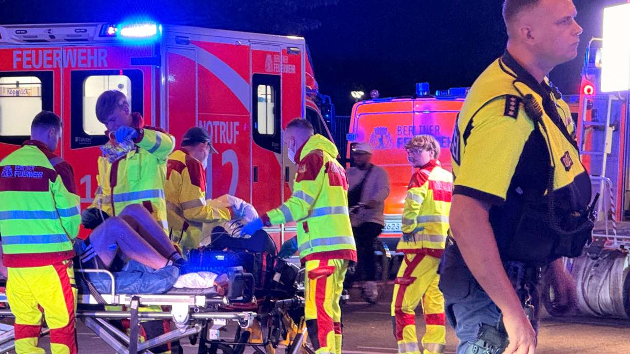 Emergency personnel tend to a person on a stretcher following the cancellation of Christopher Street Day in Berlin on Saturday. A suspect in the van attack at the event was identified on Sunday, but he has not been arrested.