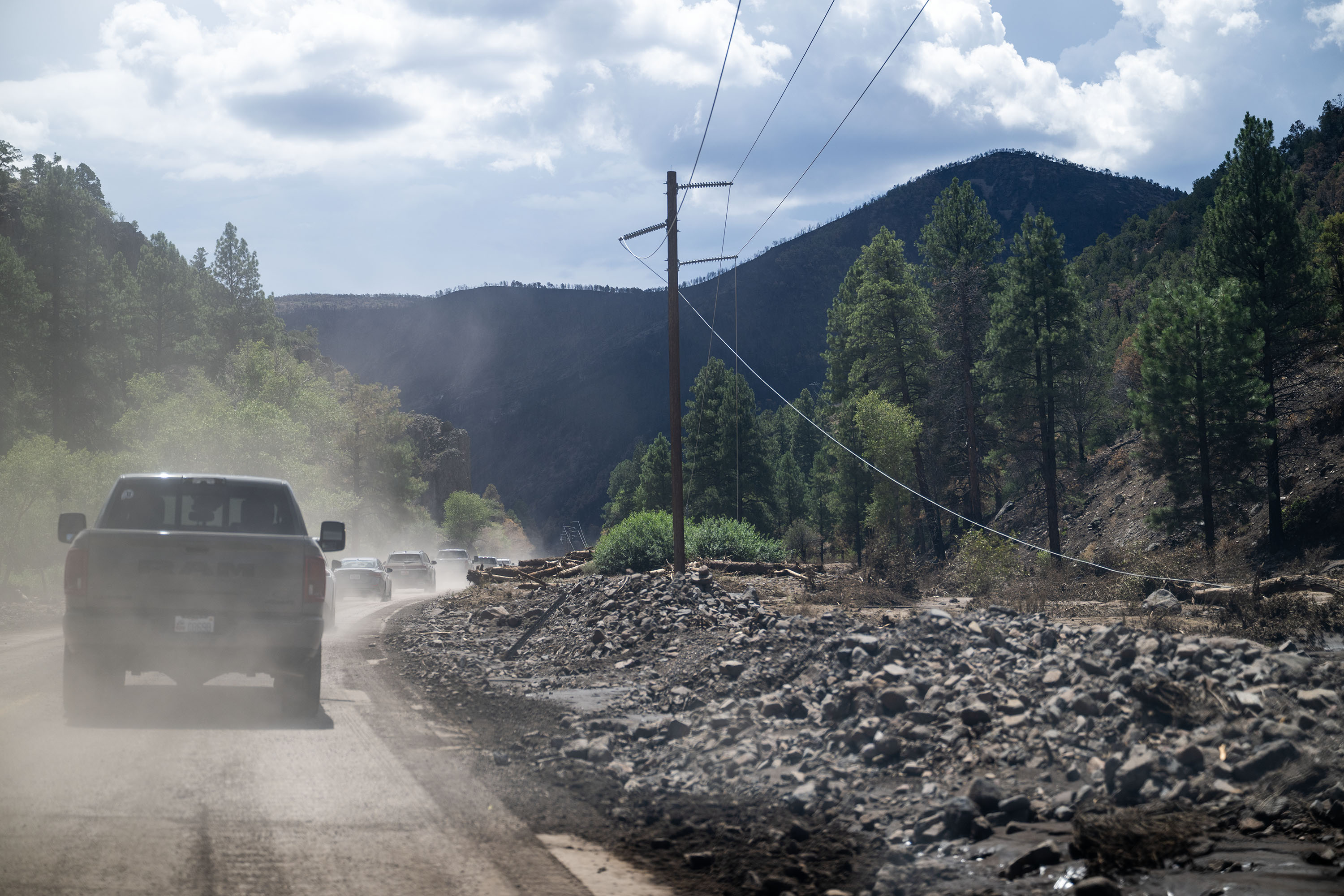 Trucks drive members of Congress and federal, state, and local officials near the Cottonwood Fire burn scar in the Fishlake National Forest on Friday. The effort was spearheaded by Rep. Celeste Maloy.
