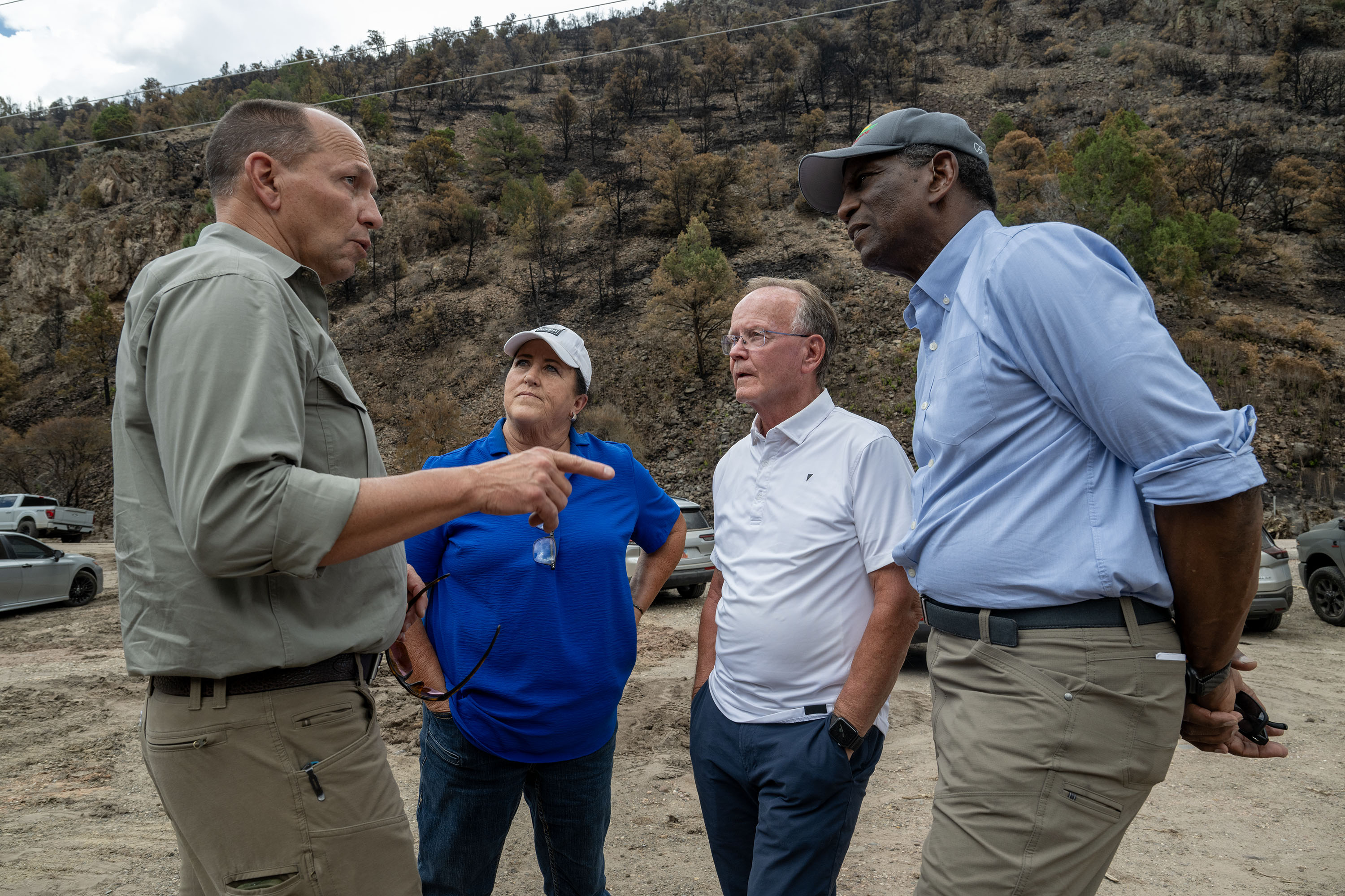Michael Boren, who serves as Undersecretary of Agriculture for Natural Resources and Environment, talks with County Commissioner Tammy Pearson, Senate President Stuart Adams, R-Layton, and Rep. Burgess Owens as members of Congress and federal, state, and local officials visit the Cottonwood Fire burn scar in the Fishlake National Forest, Friday. Boren said his team is trying to streamline the forest management process.