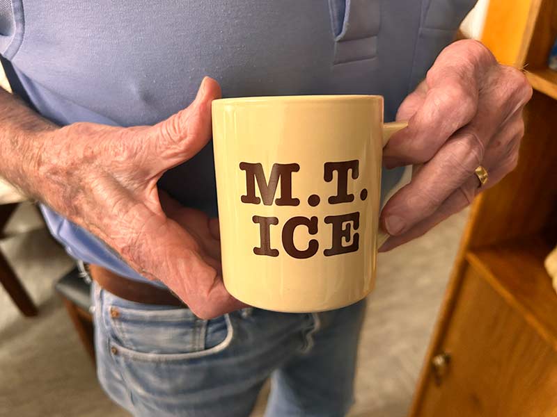 Jack Magnusson holds an old mug with the name of his now-defunct ice business printed on it, Tuesday. Magnusson understands what it would've meant to have the ice business succeed.