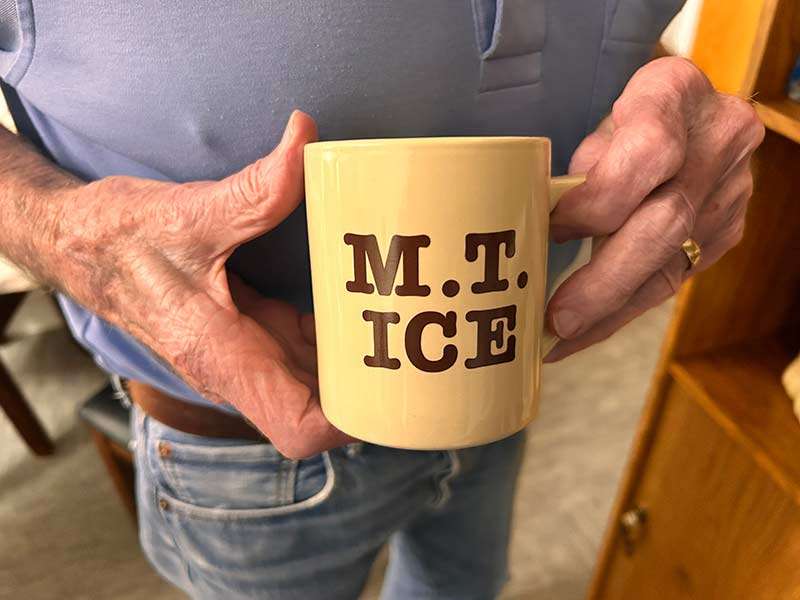 Jack Magnusson holds an old mug with the name of his now-defunct ice business printed on it, Tuesday. Magnusson understands what it would've meant to have the ice business succeed.