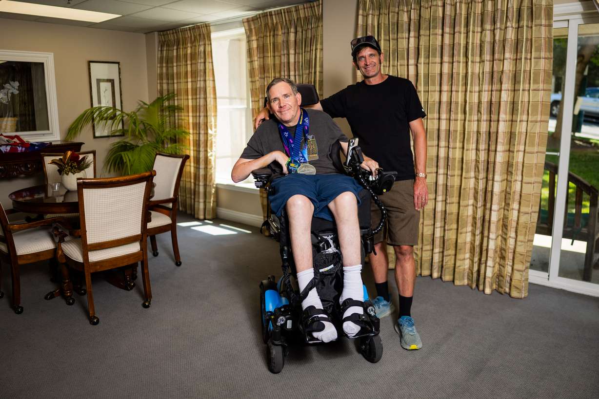 Danny Connolly and his brother Brian Connolly, who has MS, in a common area at Brian's condominium in Salt Lake City on Tuesday. The Connollys ran in Friday's Deseret News Marathon.