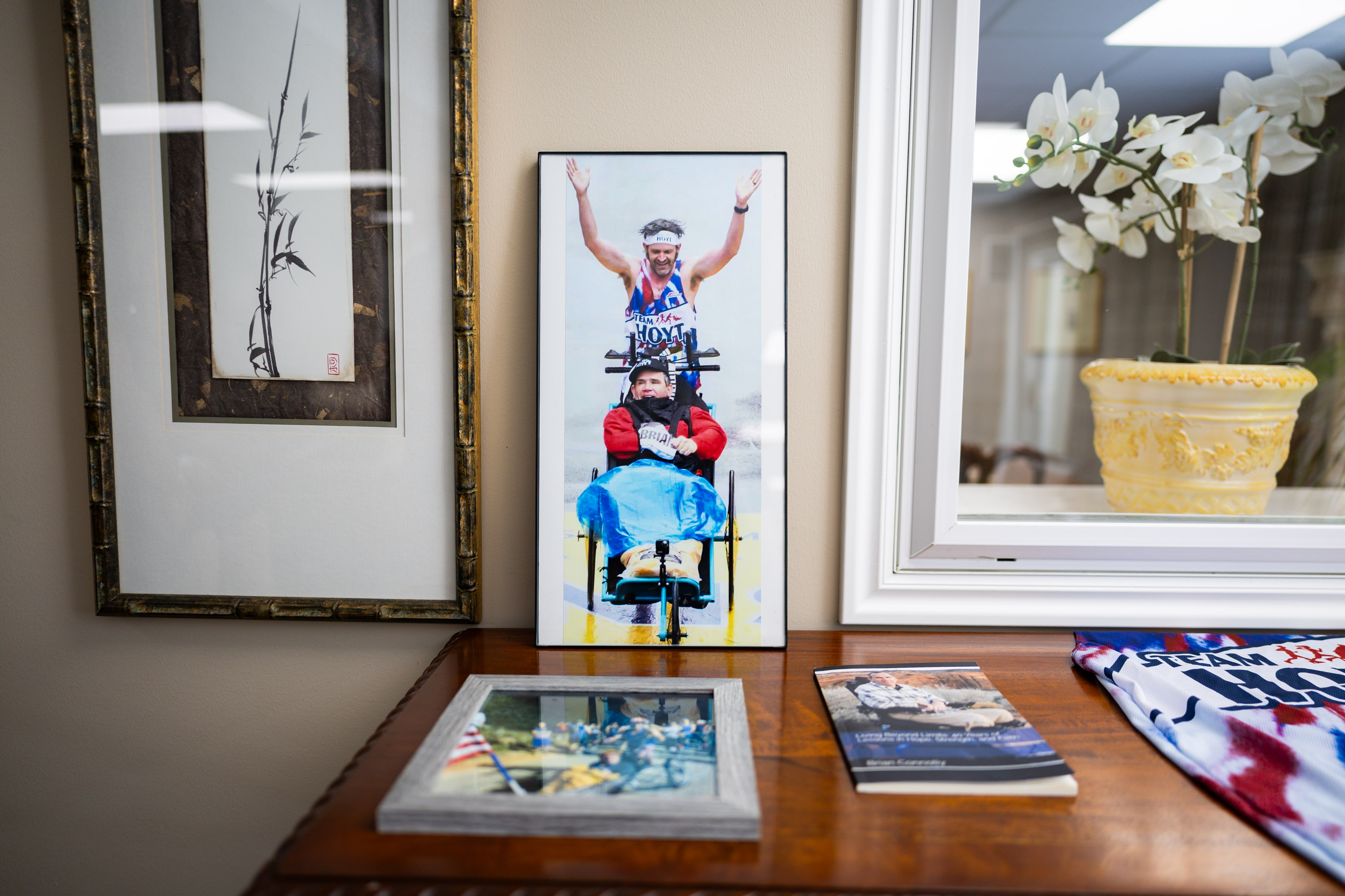 A photo of Danny Connolly and his brother Brian Connolly, who has MS, crossing the finish line at the Boston Marathon in a common area at Brian's condominium in Salt Lake City on Tuesday. The Connollys also ran in Friday's Deseret News Marathon.