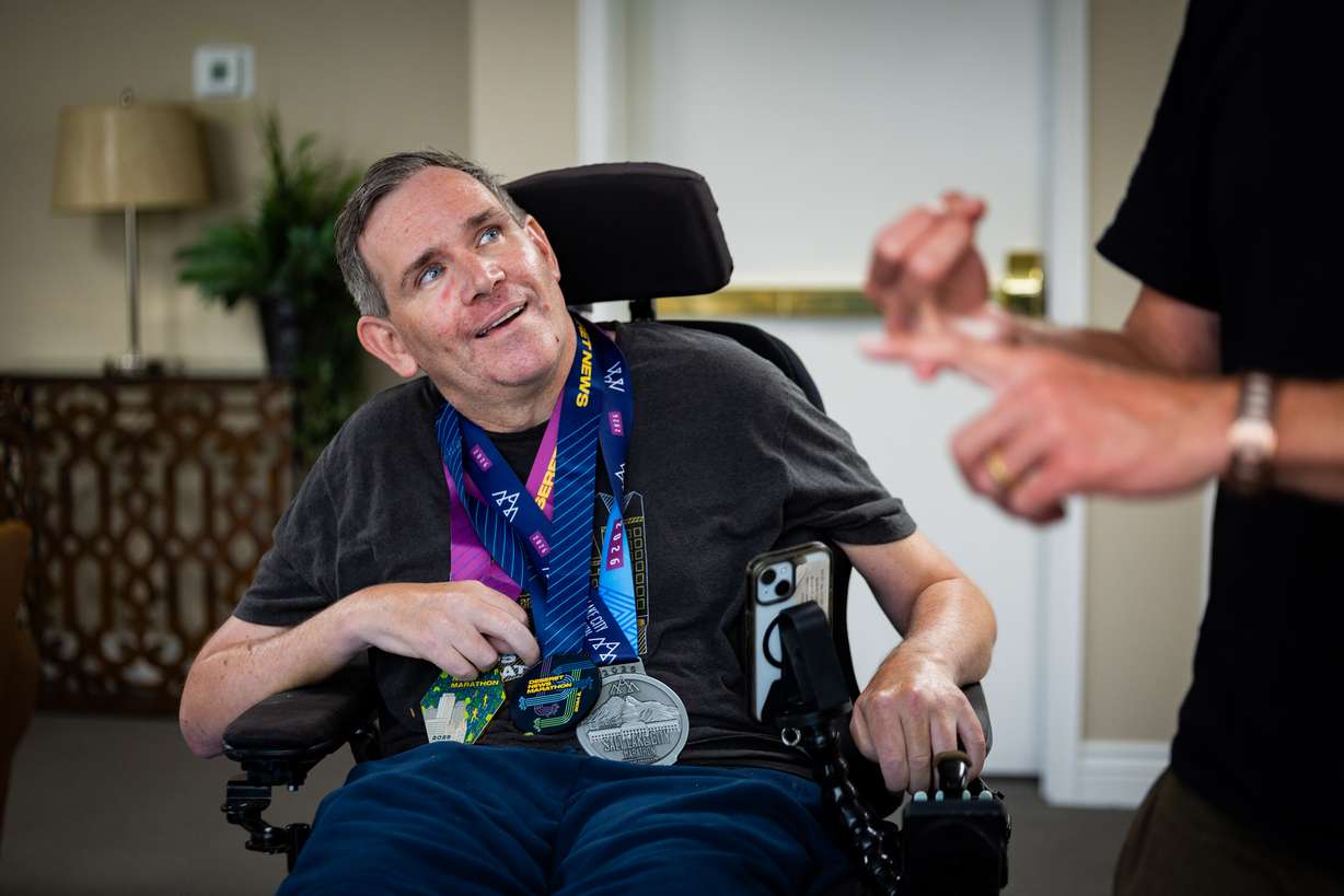 Danny Connolly and his brother Brian Connolly, who has MS, speak with the Deseret News in a common area at Brian's condominium in Salt Lake City on Tuesday. The Connollys also ran in Friday's Deseret News Marathon.