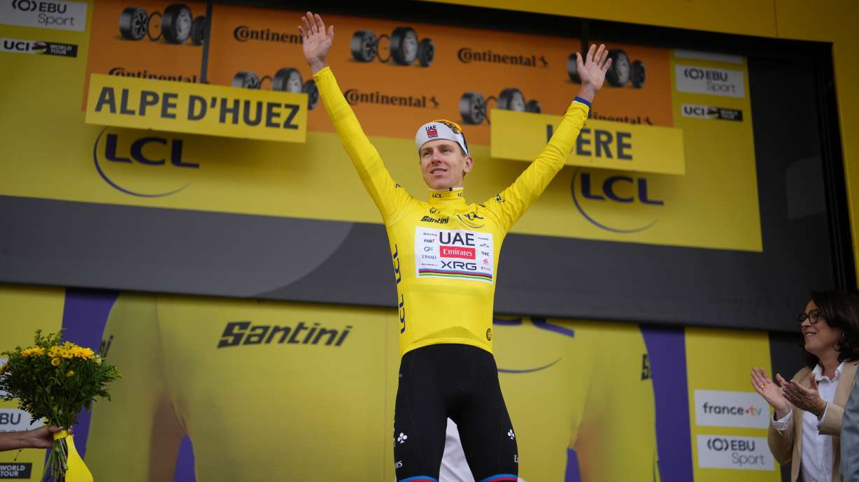 Slovenia's Tadej Pogacar, wearing the overall leader's yellow jersey, celebrates on the podium after the twentieth stage of the Tour de France cycling race with start in Le Bourg d'Oisans and finish in Alpe d'huez, France, Saturday, July 25, 2026.
