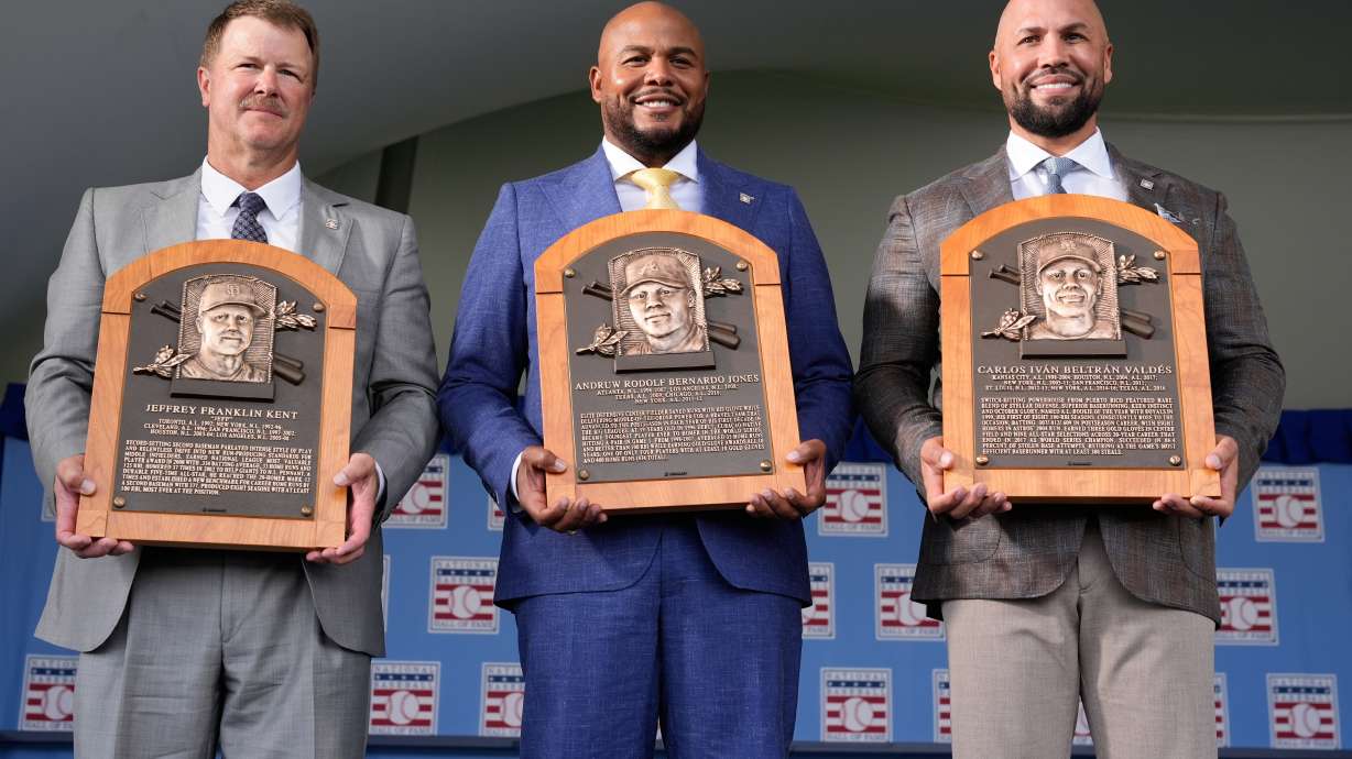 The 2026 Baseball Hall of Fame inductees Jeff Kent, left, Andruw Jones, center, and Carlos Beltran pose for pictures after the induction ceremony in Cooperstown, N.Y., Sunday, July 26, 2026.