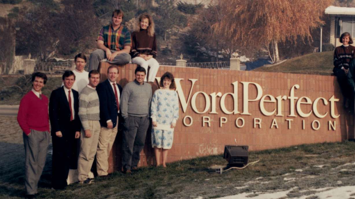 Several WordPerfect employees, including Bruce Bastian and Alan Ashton, pose for a photo outside the company office in Highland.