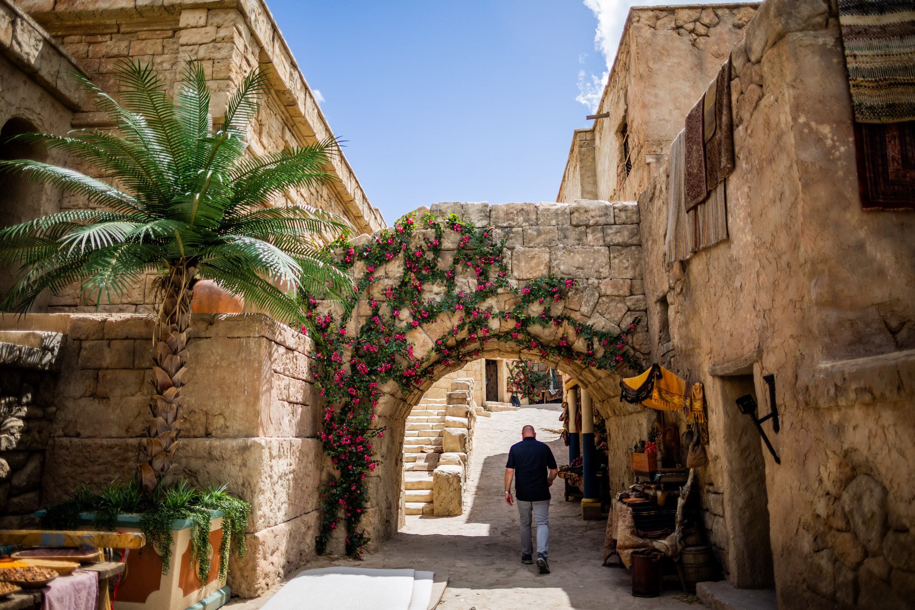 B.J. Forman, the art department coordinator for “The Chosen,” walks under the Triumphal Entry on the set of "The Chosen" in Goshen, Utah County, on May 14, 2025.