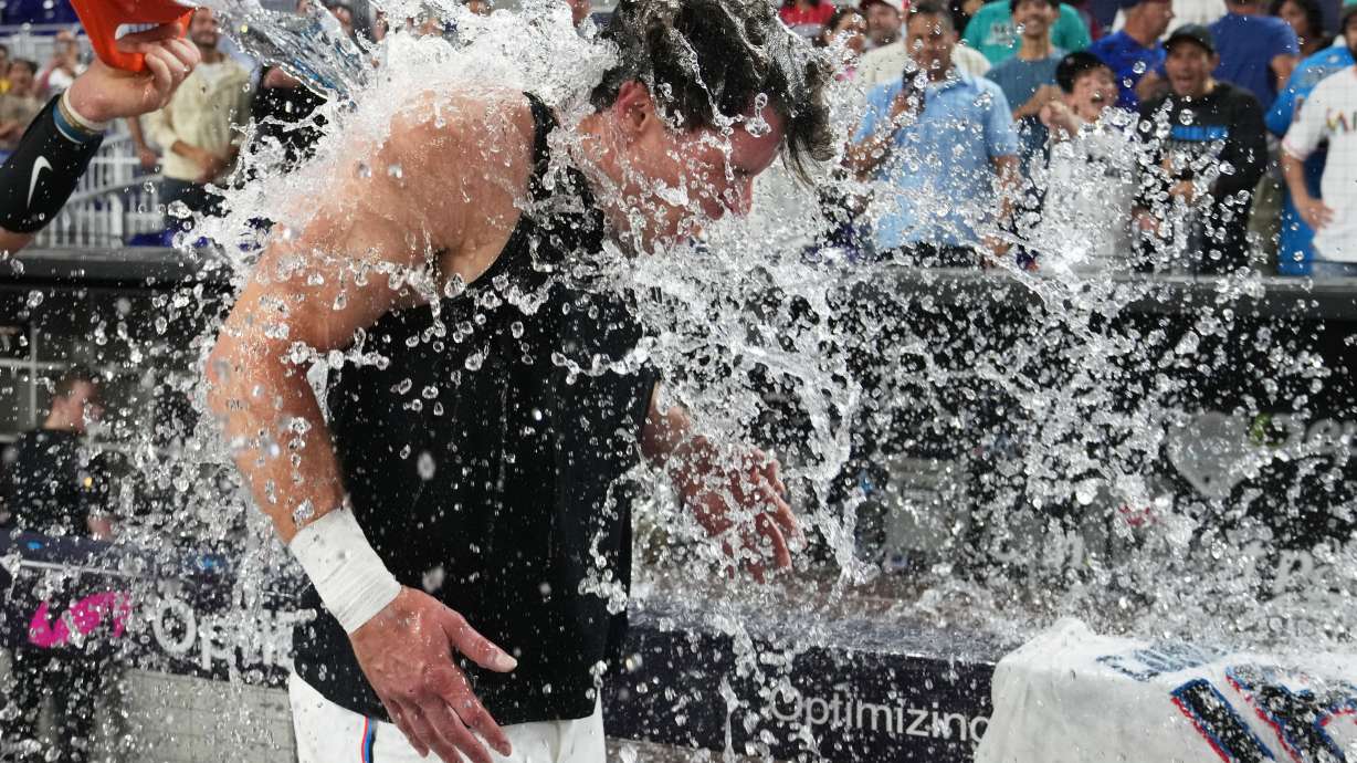 Miami Marlins' Griffin Conine, right, is doused after hitting a walk off single to defeat the Philadelphia Phillies in the the ninth inning of a baseball game, Monday, July 27, 2026, in Miami.
