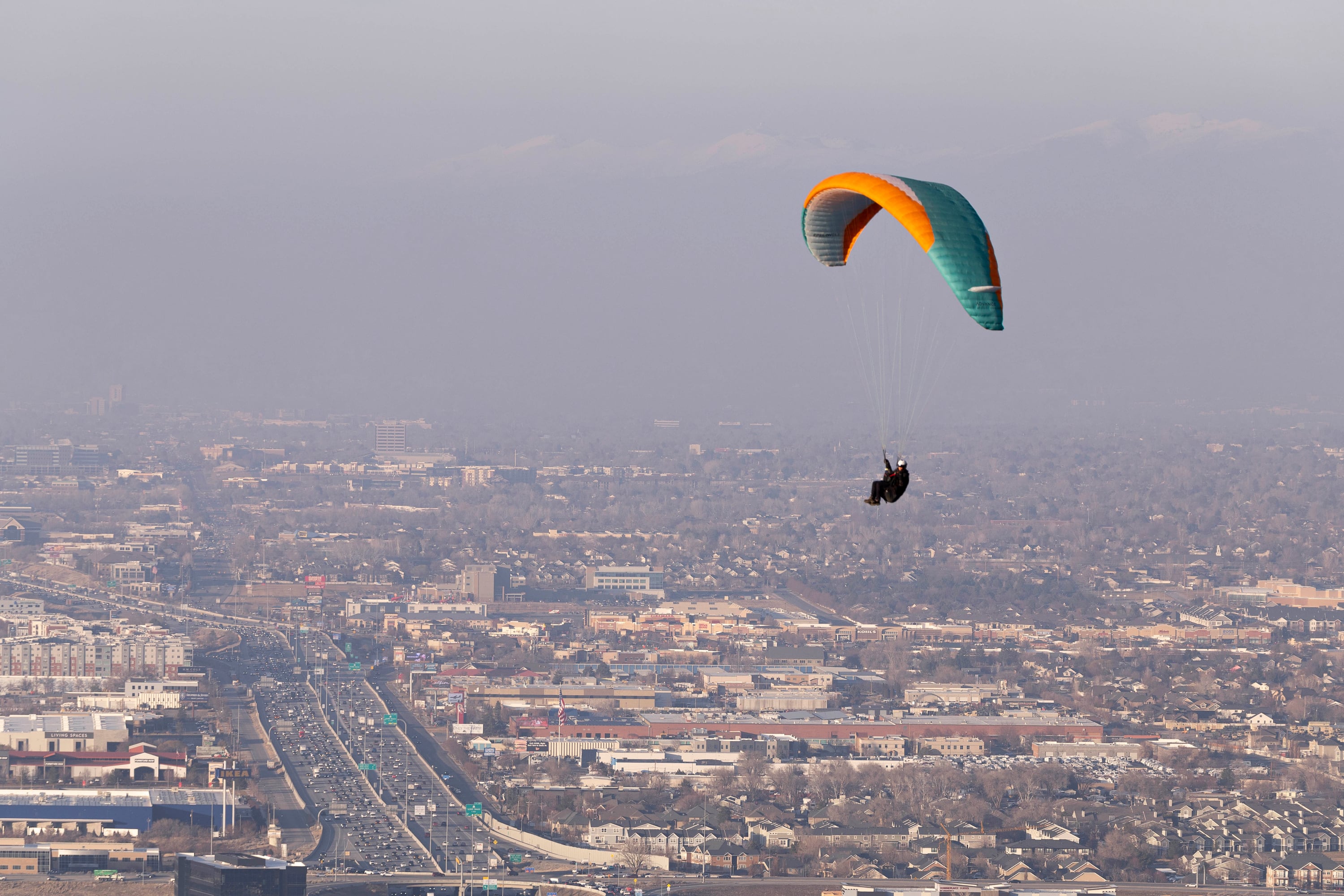 A paraglider flies above smog from an inversion at the Salt Lake County Flight Park in Draper on Jan. 16. Air quality is the main reason for Utah's lag in U.S. News & World Report's Natural Environment ranking.