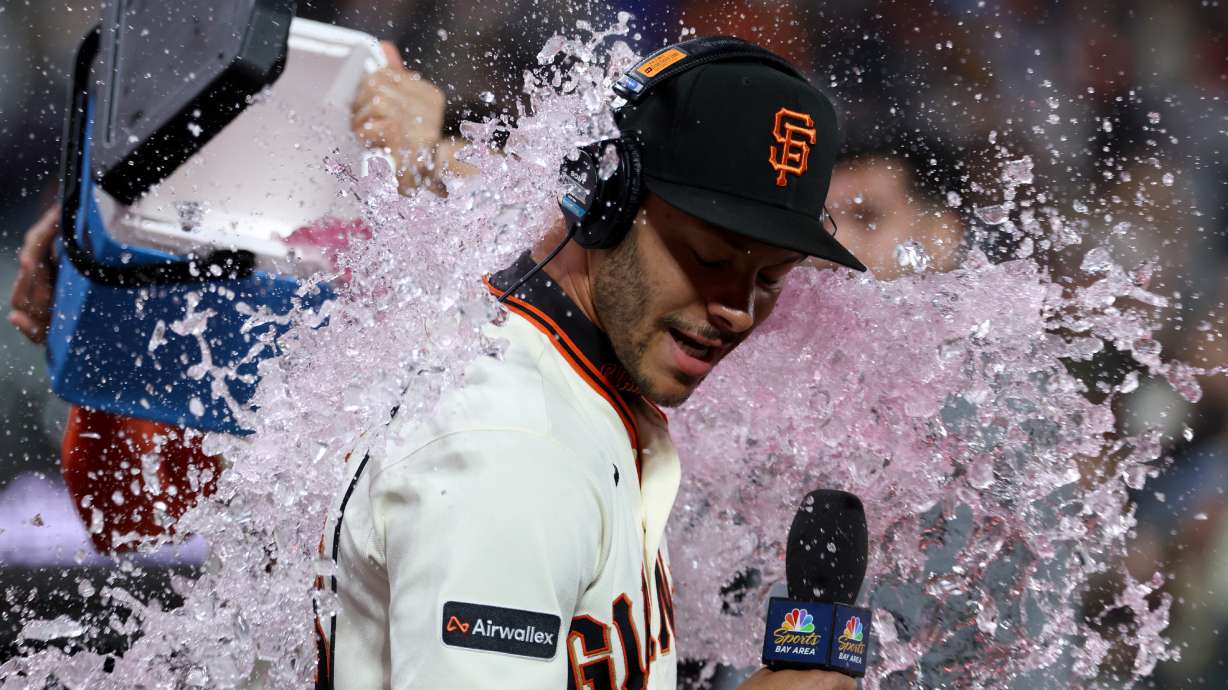 San Francisco Giants' Grant McCray is doused by teammates after their team's victory over the Milwaukee Brewers during a baseball game in San Francisco, Monday, July 27, 2026.
