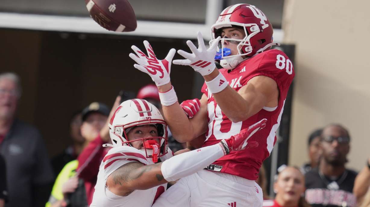 FILE - Indiana wide receiver Charlie Becker makes a touchdown catch over Wisconsin safety Austin Brown (9) during the first half of an NCAA college football game, Saturday, Nov. 15, 2025, in Bloomington, Ind.