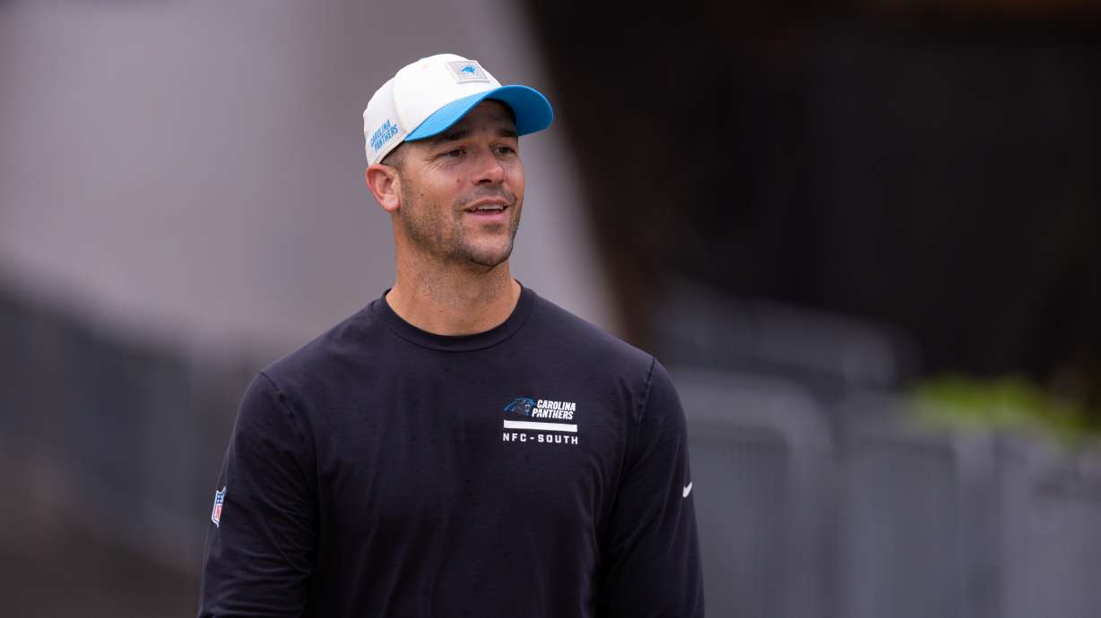 Carolina Panthers head coach Dave Canales walks up to the field forc} the NFL football team's training camp Friday, July 24, 2026, in Charlotte, N.C.