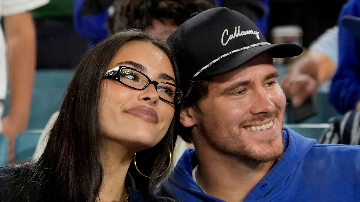 FILE - Los Angeles Chargers quarterback Justin Herbert and girlfriend Madison Beer watch the Toronto Blue Jays and the Los Angeles Dodgers compete during the seventh inning in Game 3 of baseball's World Series, Monday, Oct. 27, 2025, in Los Angeles.