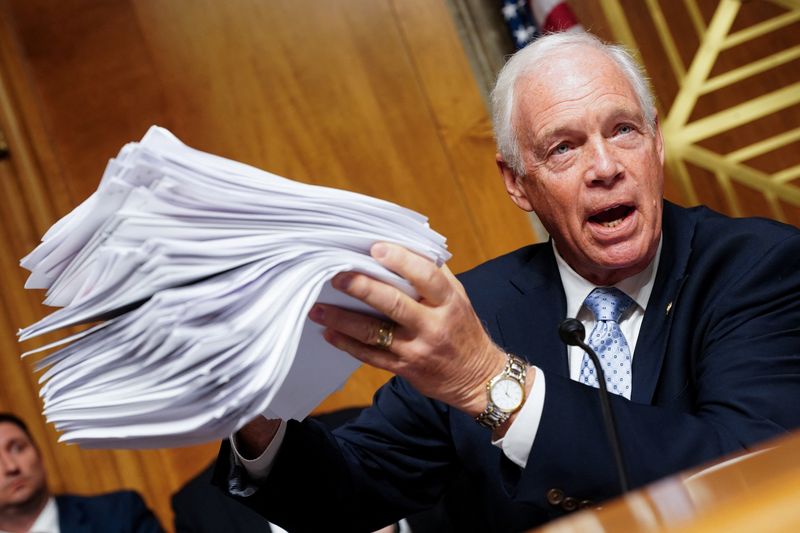Sen. Ron Johnson, R-Wis., holds up what he says are studies on Ivermectin during a hearing with Anthony Fauci, the former Director of the National Institute of Allergy and Infectious Diseases and medical adviser to several presidents, on Capitol Hill in Washington, Wednesday. Fauci refused to answer any questions, invoking his Fifth Amendment rights.