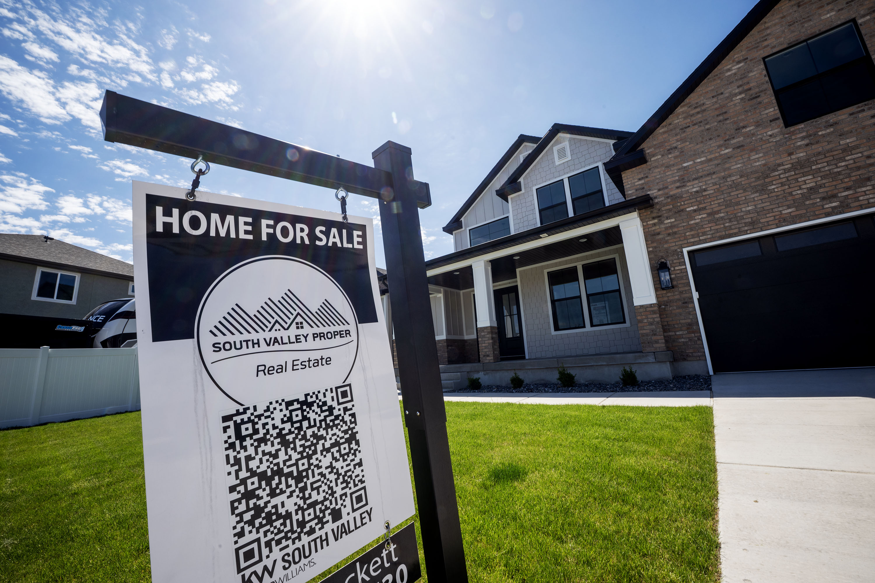 A for-sale sign stands in front of a home in West Jordan on May 12. Scott Colemere, president of the Salt Lake Board of Realtors, said recovery in what he described as a "bipolar" housing market in Utah is seen in new data, but consumer fears loom.