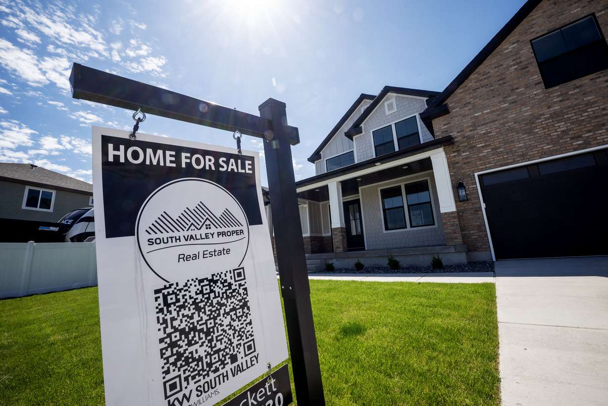A for-sale sign stands in front of a home in West Jordan on May 12. Scott Colemere, president of the Salt Lake Board of Realtors, said recovery in what he described as a "bipolar" housing market in Utah is seen in new data, but consumer fears loom.