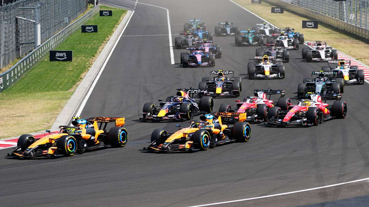 McLaren driver Lando Norris of Britain, left, leads the field after the start during the Formula One Hungarian Grand Prix auto race, at the Hungaroring racetrack in Mogyorod, near Budapest, Hungary, Sunday, July 26, 2026.