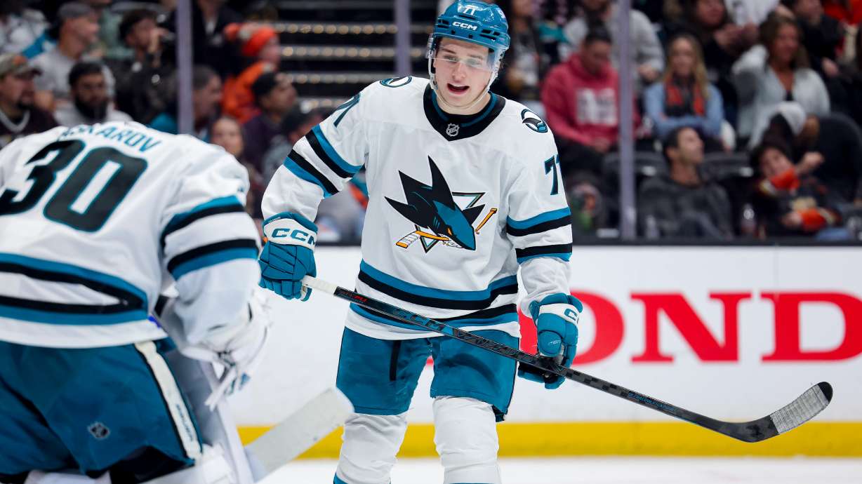 FILE - San Jose Sharks center Macklin Celebrini, right, talks with goaltender Yaroslav Askarov during the third period of an NHL hockey game against the Anaheim Ducks, April 9, 2026, in Anaheim, Calif.