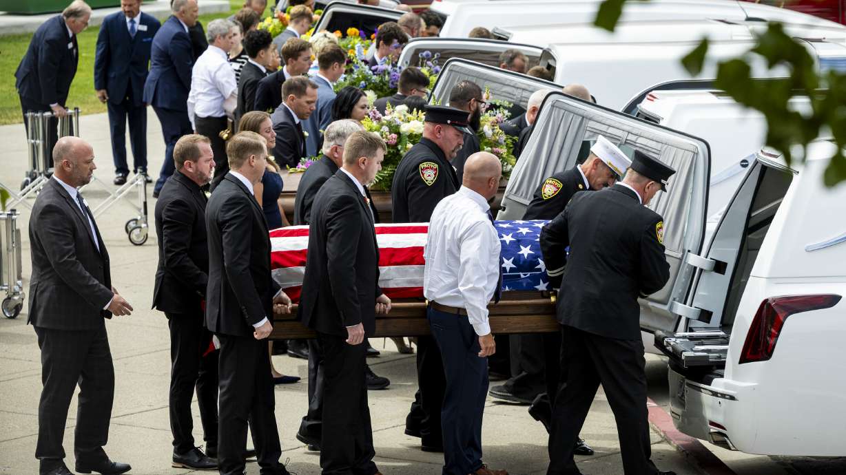 Pallbearers load the caskets of Provo Fire Capt. Spencer Long, his wife Katrina, and three of their four children — Reid, 20, Thayne, 13, and Gage, 12 — after the family’s funeral at the UCCU Center in Orem on Wednesday.