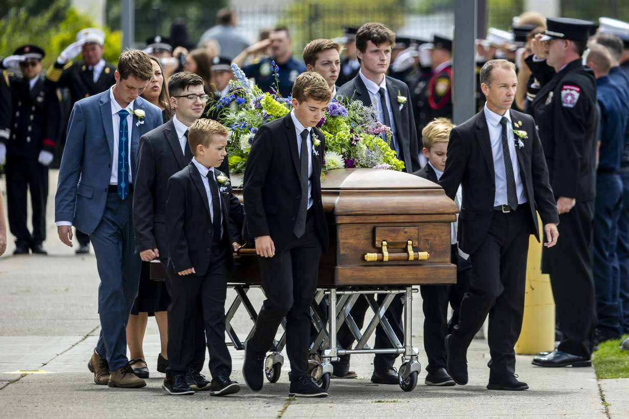 The casket of one of the three late Long family children is brought toward a hearse by pallbearers after the family’s funeral at the UCCU Center in Orem on Wednesday. The service was held for Long, his wife Katrina, and three of their four children — Reid, 20, Thayne, 13, and Gage, 12 — who all died in a flash flood in Wayne County on July 17.